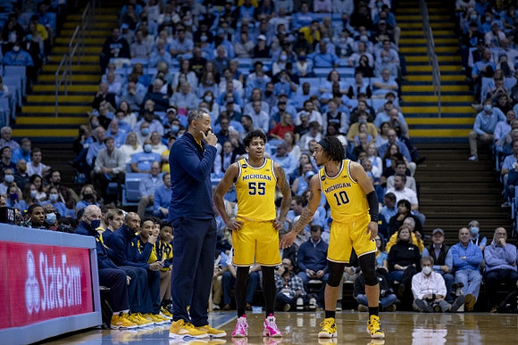 Juwan Howard, Eli Brooks (55), and Frankie Collins (10)