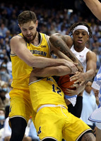 Hunter Dickinson (1) and DeVante' Jones (12)