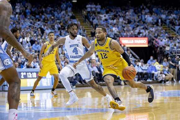 Caleb Houstan (22) and DeVante' Jones (12)