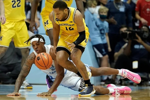 DeVante' Jones (12) and Caleb Houstan (22)