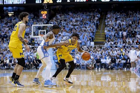 Brandon Johns Jr. (23) and Eli Brooks (55)