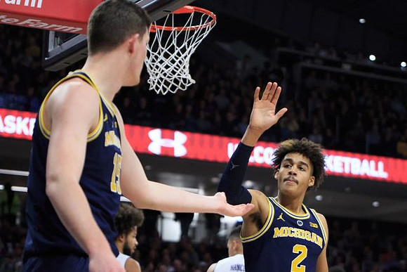 Jon Teske (15) and Jordan Poole (2)