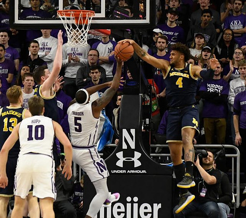 Ignas Brazdeikis (13), Jon Teske (15), and Isaiah Livers (4)