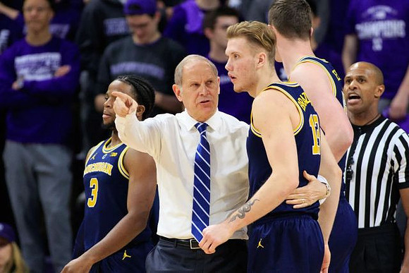 Zavier Simpson (3), John Beilein, Ignas Brazdeikis (13), and Jon Teske (15)