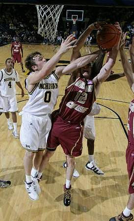 Zack Novak (0) and Darius Morris (4)