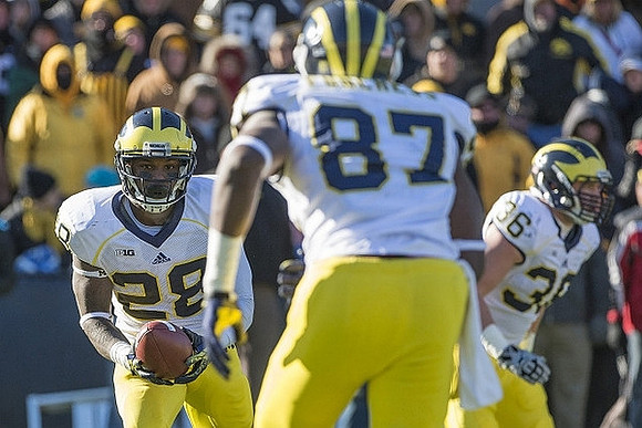 Fitzgerald Toussaint (28), Devin Funchess (87), and Joe Kerridge (36)