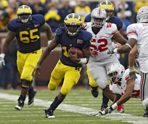 Patrick Omameh (65) and Denard Robinson (16)