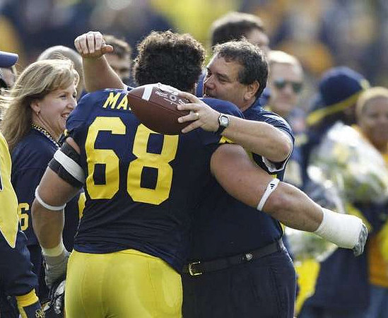 Mike Martin (68) and Brady Hoke