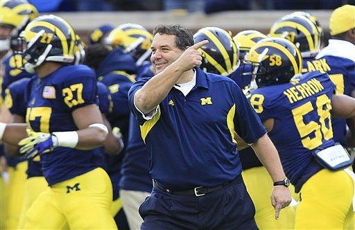 Mike Jones (27), Brady Hoke, Brandon Herron (58), and Frank Clark (57)