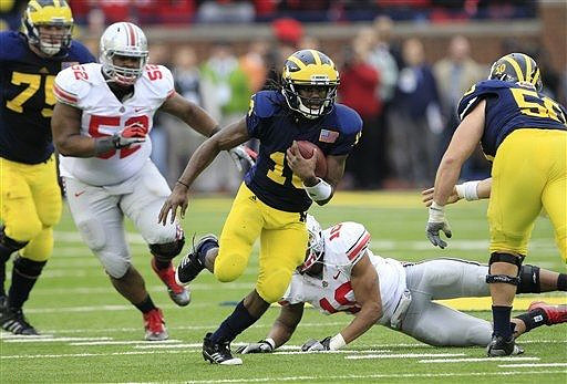 Michael Schofield (75), Denard Robinson (16), and David Molk (50)