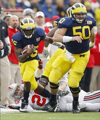 Denard Robinson (16), Patrick Omameh (65), and David Molk (50)