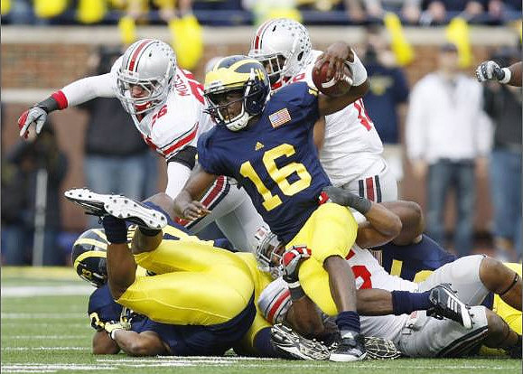 Stephen Hopkins (33), Denard Robinson (16), and Patrick Omameh (65)
