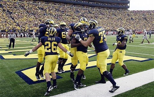 Drew Dileo (26), Junior Hemingway (21), Patrick Omameh (65), Taylor Lewan (77), Denard Robinson (16), Michael Schofield (75), and Fitzgerald Toussaint (28)