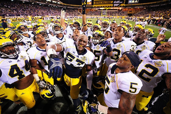 Delano Hill (44), Frank Clark (57), Justice Hayes (5), Taco Charlton (33), and Michigan Team