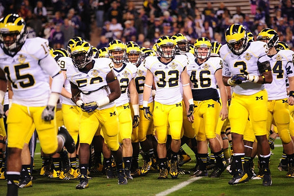 James Ross (15), Shaun Austin (32), J.J. McGrath (46), Mike McCray (3), and Michigan Team