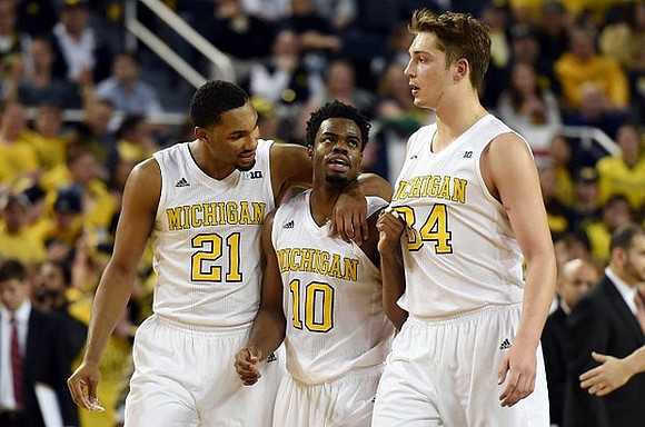 Zak Irvin (21), Derrick Walton Jr. (10), and Mark Donnal (34)