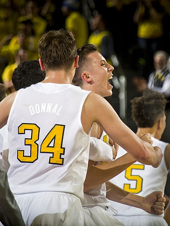 Mark Donnal (34), Duncan Robinson (22), and D.J. Wilson (5)