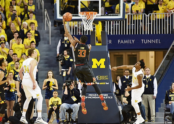 Mark Donnal (34) and Derrick Walton Jr. (10)