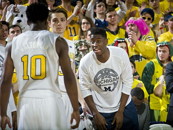 Derrick Walton Jr. (10), Mark Donnal (34), and Caris LeVert (23)