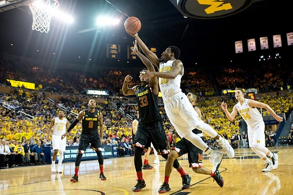 Zak Irvin (21), Derrick Walton Jr. (10), and Mark Donnal (34)