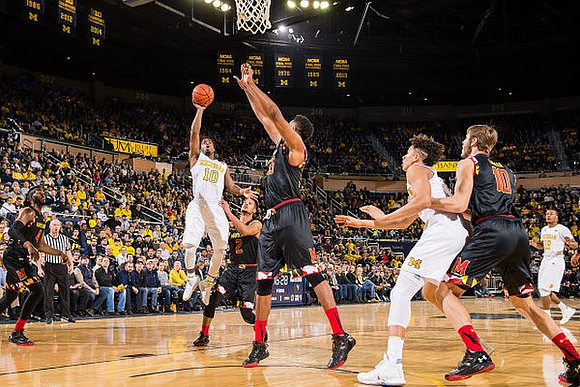 Derrick Walton Jr. (10), D.J. Wilson (5), and Muhammad-Ali Abdur-Rahkman (12)