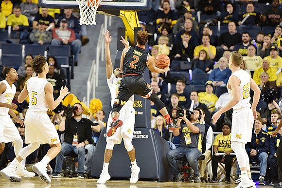 Zak Irvin (21), D.J. Wilson (5), Muhammad-Ali Abdur-Rahkman (12), and Duncan Robinson (22)