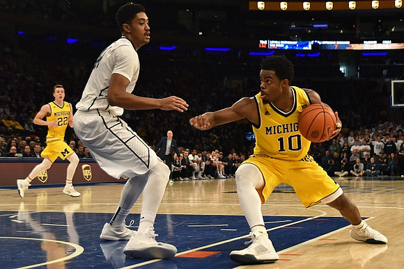 Duncan Robinson (22) and Derrick Walton Jr. (10)