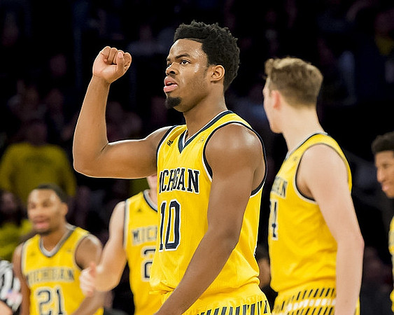 Zak Irvin (21), Derrick Walton Jr. (10), and Mark Donnal (34)