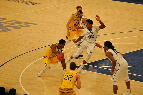 Derrick Walton Jr. (10), Duncan Robinson (22), and Mark Donnal (34)