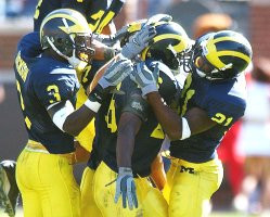 Julius Curry (26), Jeremy LeSueur (21), and CB Marlin Jackson (3)