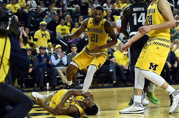 Derrick Walton Jr. (10), Zak Irvin (21), and Mark Donnal (34)