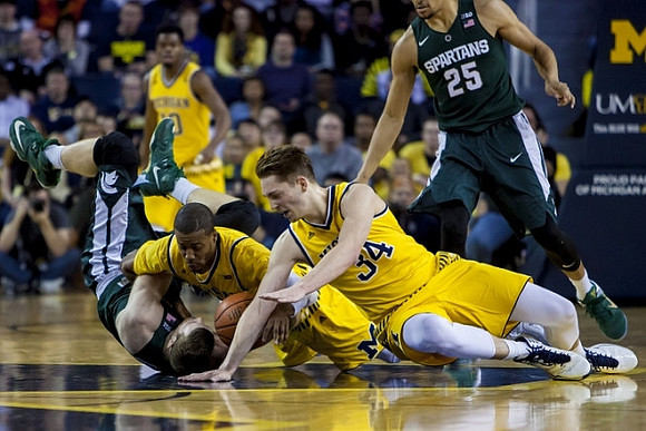 Derrick Walton Jr. (10), Muhammad-Ali Abdur-Rahkman (12), and Mark Donnal (34)