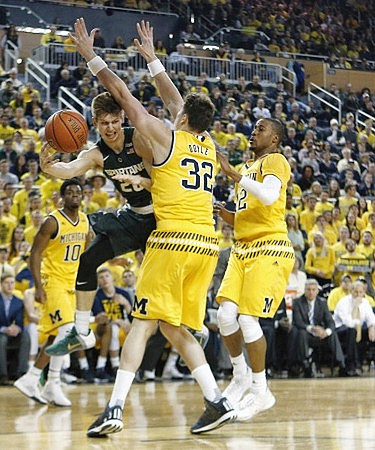 Derrick Walton Jr. (10), Ricky Doyle (32), and Muhammad-Ali Abdur-Rahkman (12)