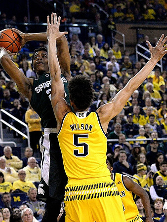 D.J. Wilson (5) and Derrick Walton Jr. (10)