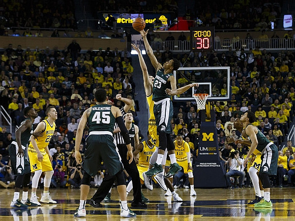 Duncan Robinson (22), Derrick Walton Jr. (10), Muhammad-Ali Abdur-Rahkman (12), and Zak Irvin (21)