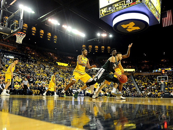 D.J. Wilson (5), Aubrey Dawkins (24), Zak Irvin (21), and Derrick Walton Jr. (10)