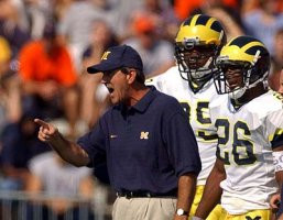 Lloyd Carr, Pierre Woods (99), and Julius Curry (26)