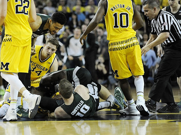 Duncan Robinson (22), Mark Donnal (34), and Derrick Walton Jr. (10)