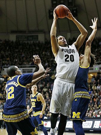 Muhammad-Ali Abdur-Rahkman (12), Duncan Robinson (22), and D.J. Wilson (5)