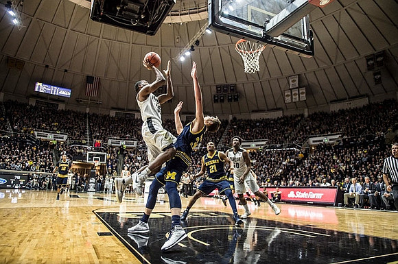 Derrick Walton Jr. (10), Mark Donnal (34), and Zak Irvin (21)