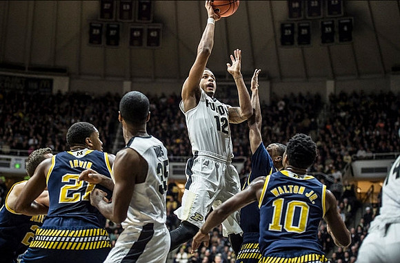 Zak Irvin (21) and Derrick Walton Jr. (10)