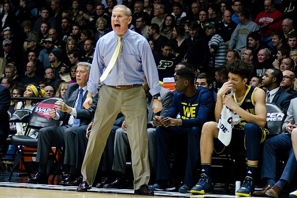 Jeff Meyer, John Beilein, Caris LeVert (23), and D.J. Wilson (5)