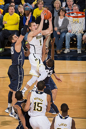 Nik Stauskas (11), Jon Horford (15), and Caris LeVert (23)