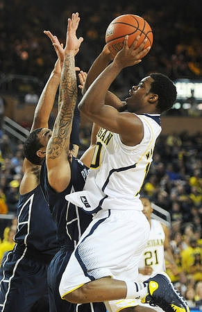 Derrick Walton Jr. (10) and Zak Irvin (21)