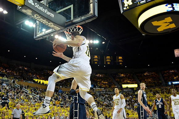 Nik Stauskas (11), Jordan Morgan (52), and Caris LeVert (23)