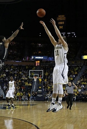 Nik Stauskas (11) and Caris LeVert (23)