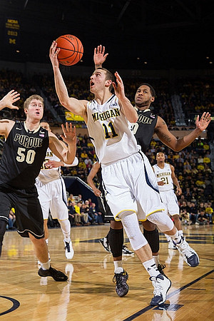 Nik Stauskas (11), Jordan Morgan (52), and Zak Irvin (21)
