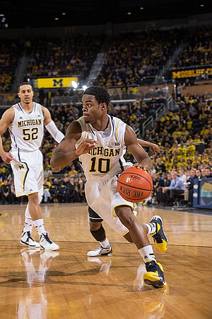 Jordan Morgan (52) and Derrick Walton Jr. (10)