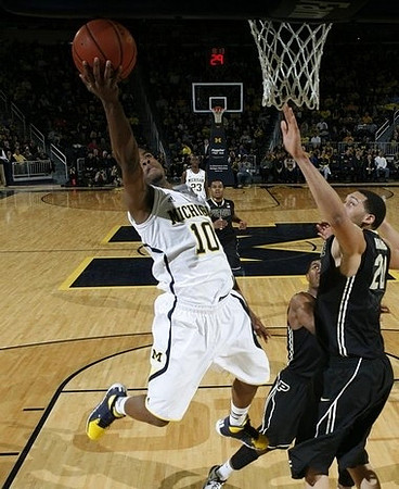 Derrick Walton Jr. (10) and Caris LeVert (23)