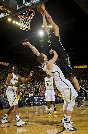 Zak Irvin (21), Caris LeVert (23), and Nik Stauskas (11)